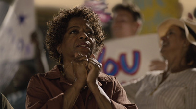 a group of people standing around each other holding signs