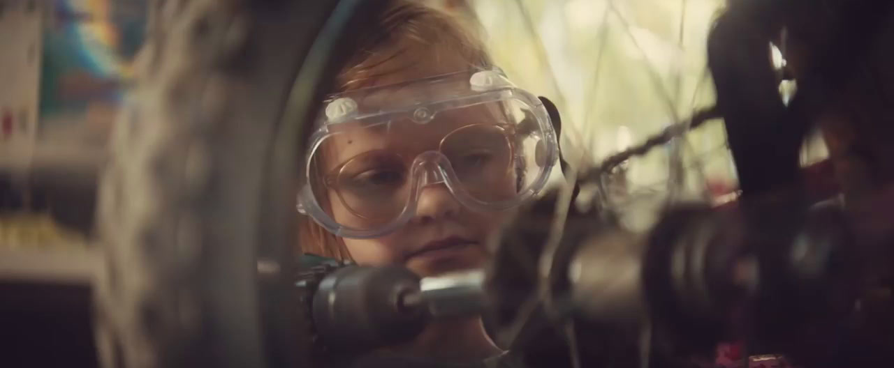 a woman wearing goggles looking through a wheel