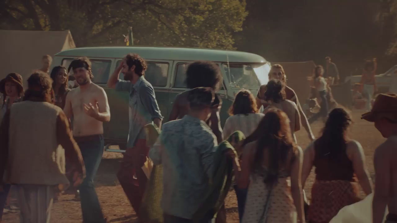 a group of people standing around a van