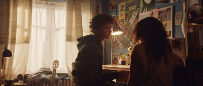 a man and a woman in a room looking at each other