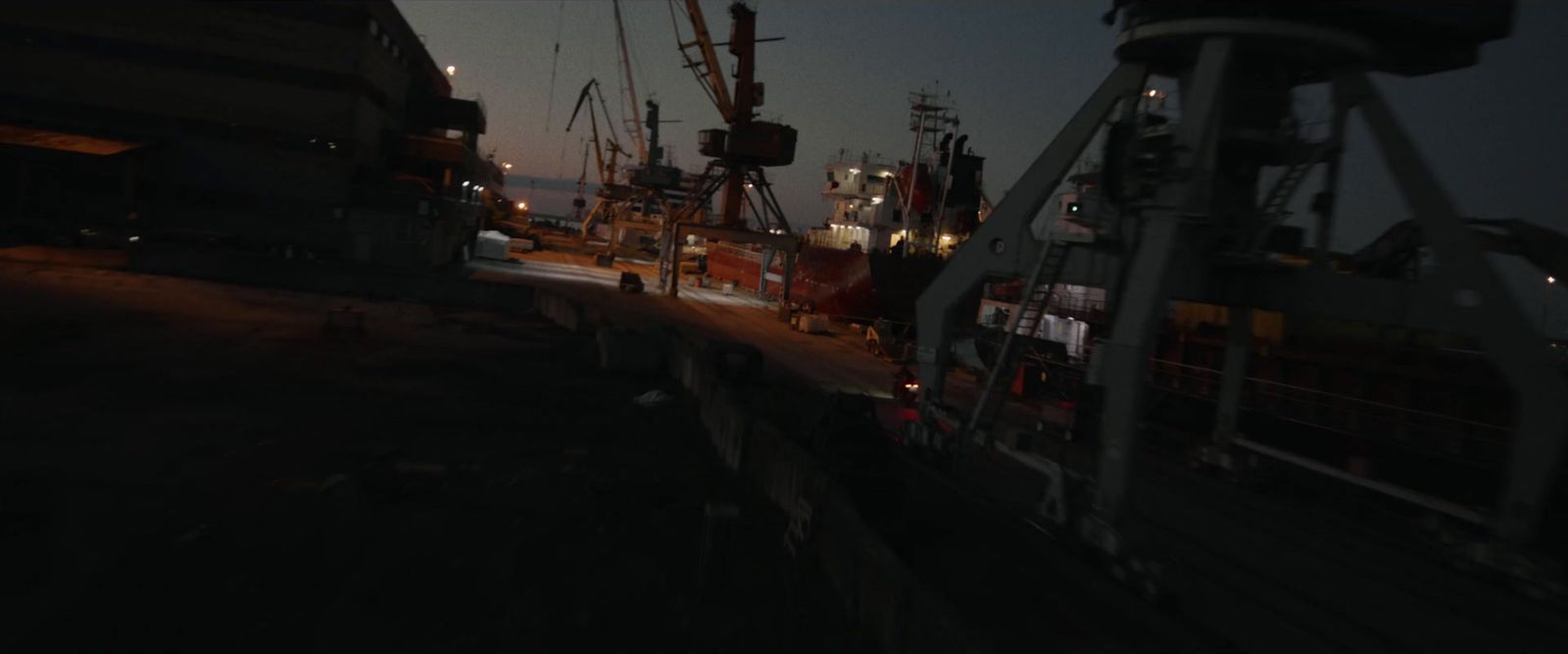 a boat is docked at a dock at night