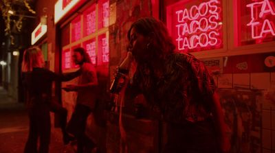 a group of people standing outside of a taco shop