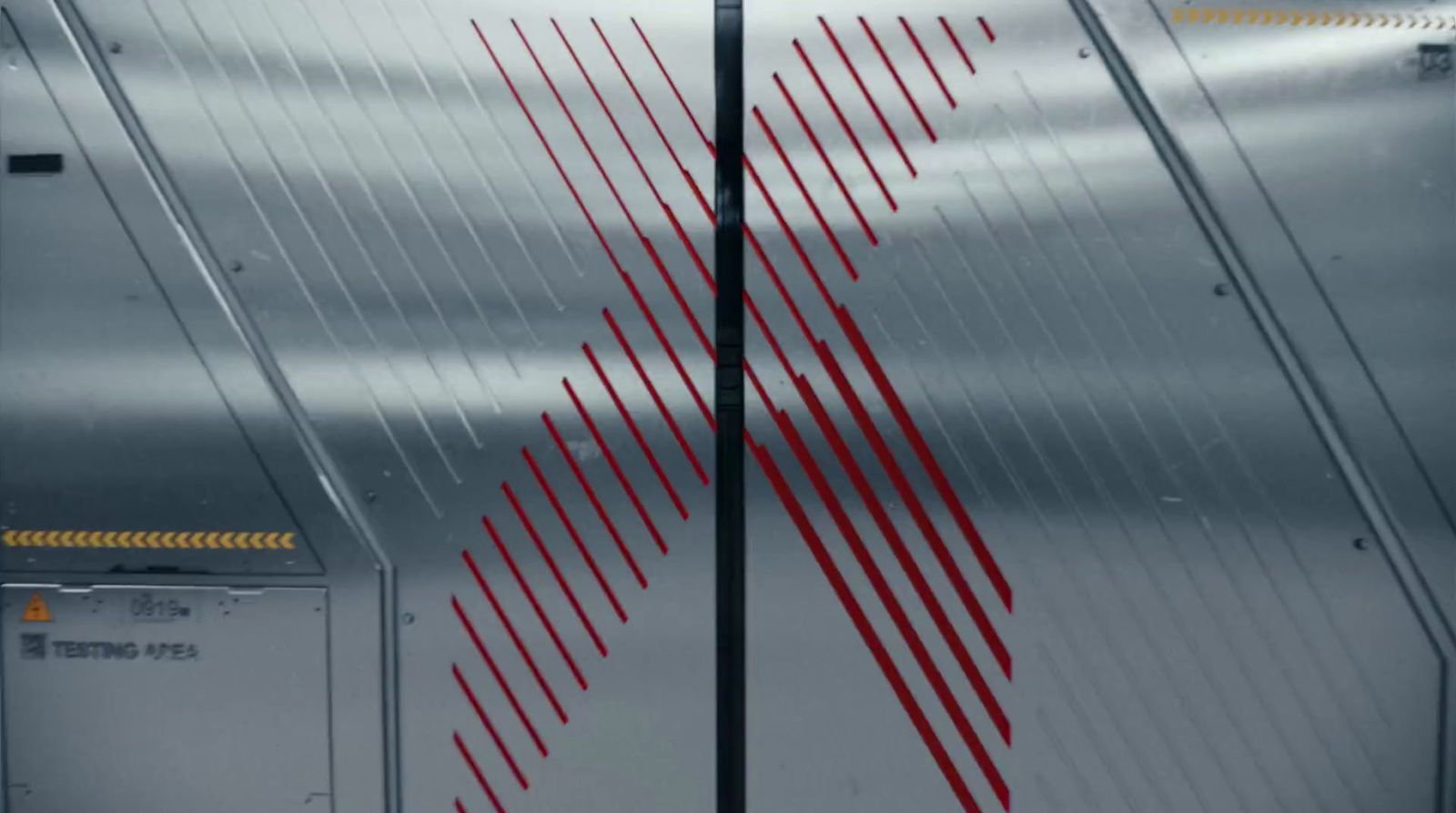 a close up of a metal door with red lines on it