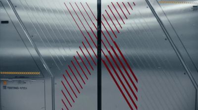 a close up of a metal door with red lines on it