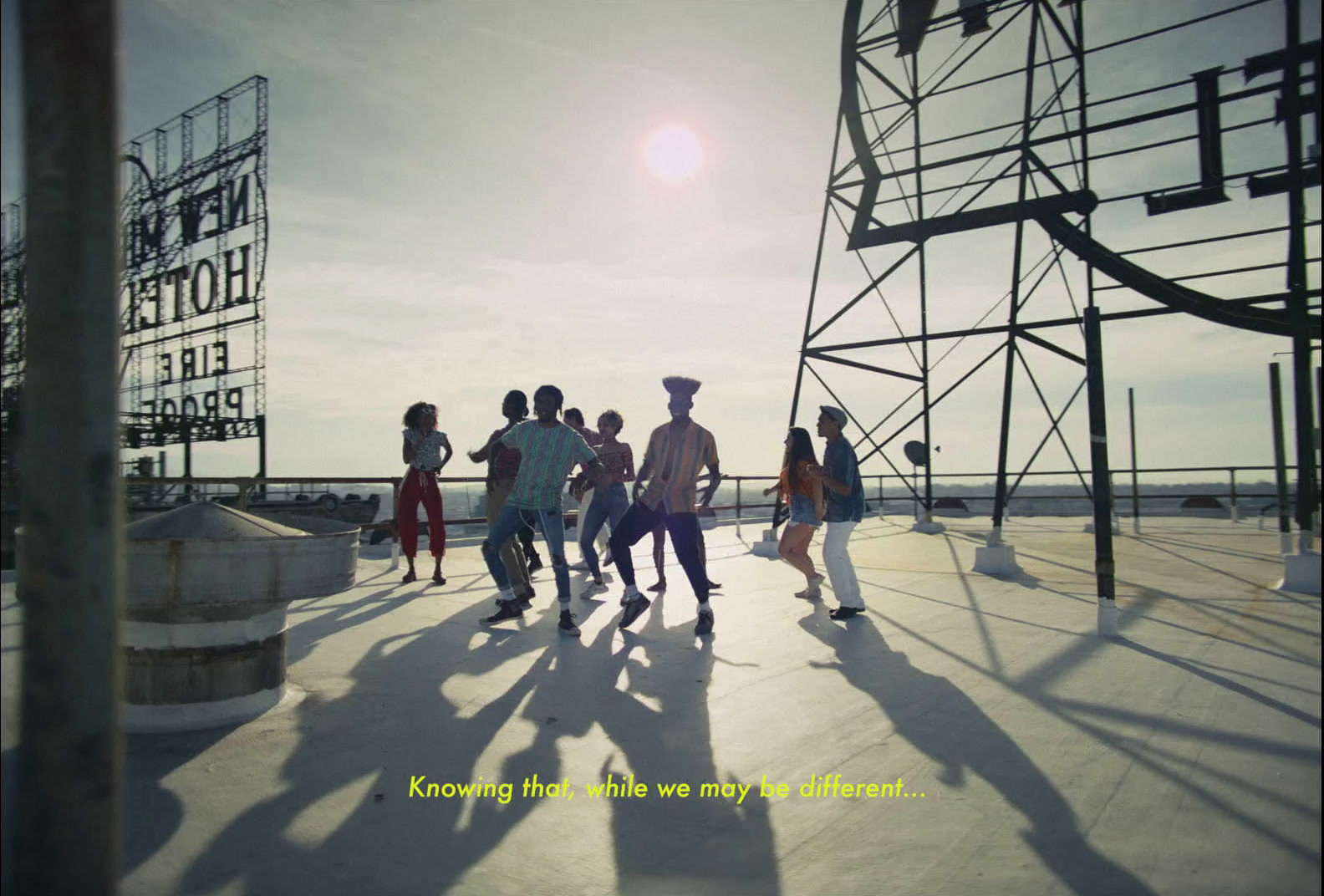 a group of people standing on top of a building