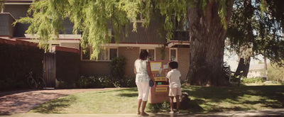 a couple of people standing in front of a tree