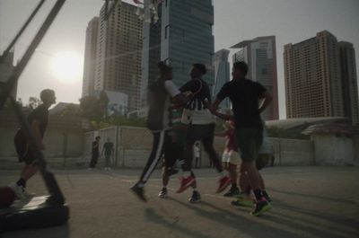 a group of young men playing a game of basketball