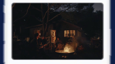 a group of people sitting around a fire pit