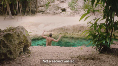 a man standing in front of a pool of water