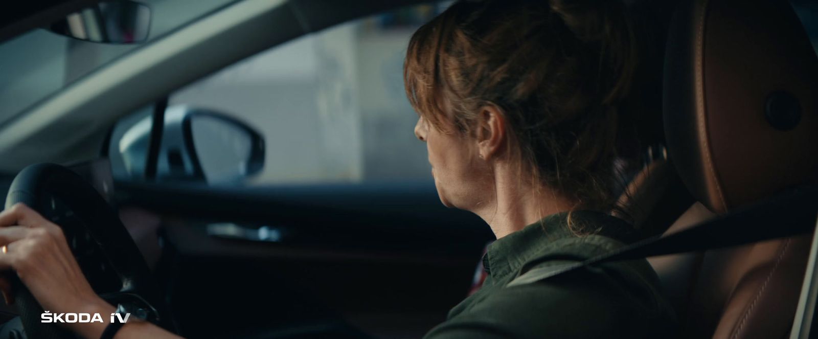 a woman driving a car in the dark