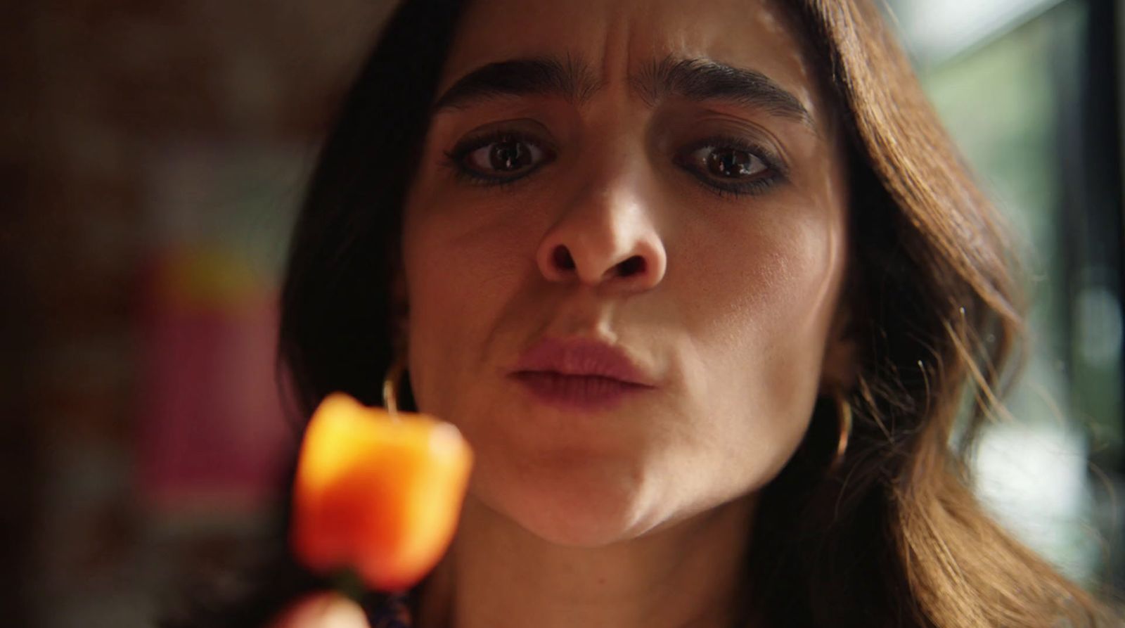 a close up of a person holding a flower