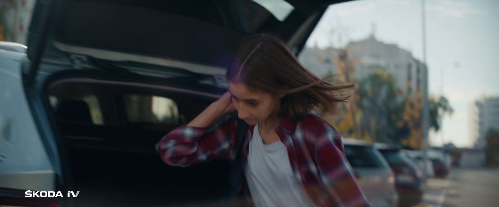 a young woman walking out of a car