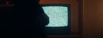 a person standing in front of a television set