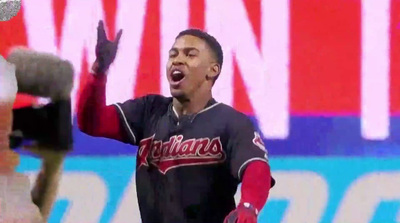 a baseball player holding his hand up in the air