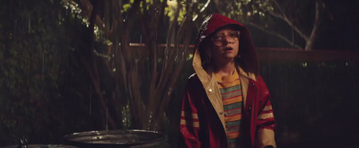 a man in a red and yellow striped shirt and a red hoodie