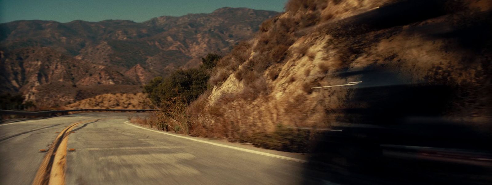 a blurry photo of a mountain road