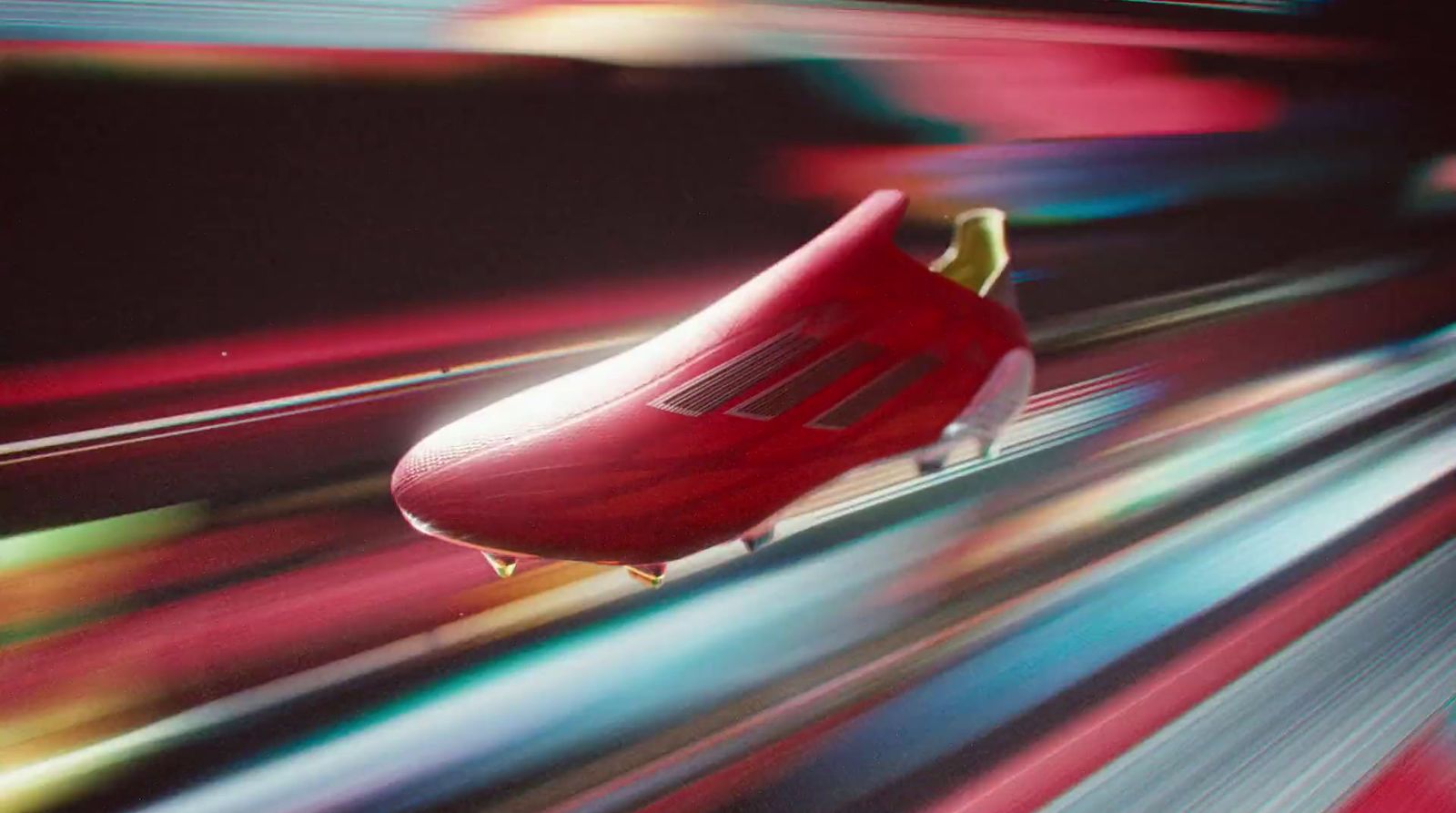 a red soccer shoe flying through the air