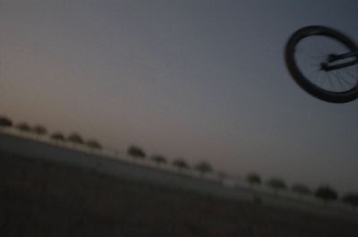 a man flying through the air while riding a bike