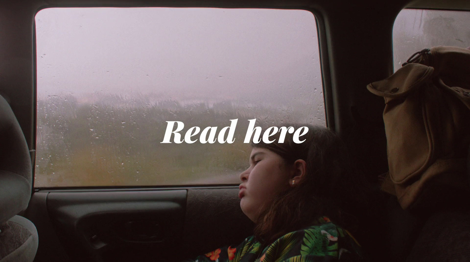 a woman sitting in the back seat of a car