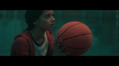 a girl holding a basketball in her hands