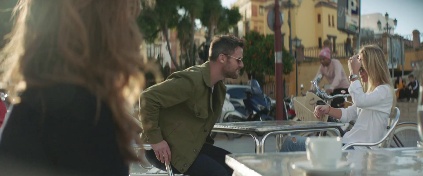 a man sitting at a table talking to a woman