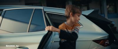 a young boy getting out of a car