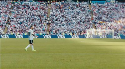 a soccer player on a field in front of a crowd