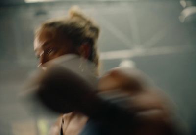 a blurry photo of a woman holding a cell phone