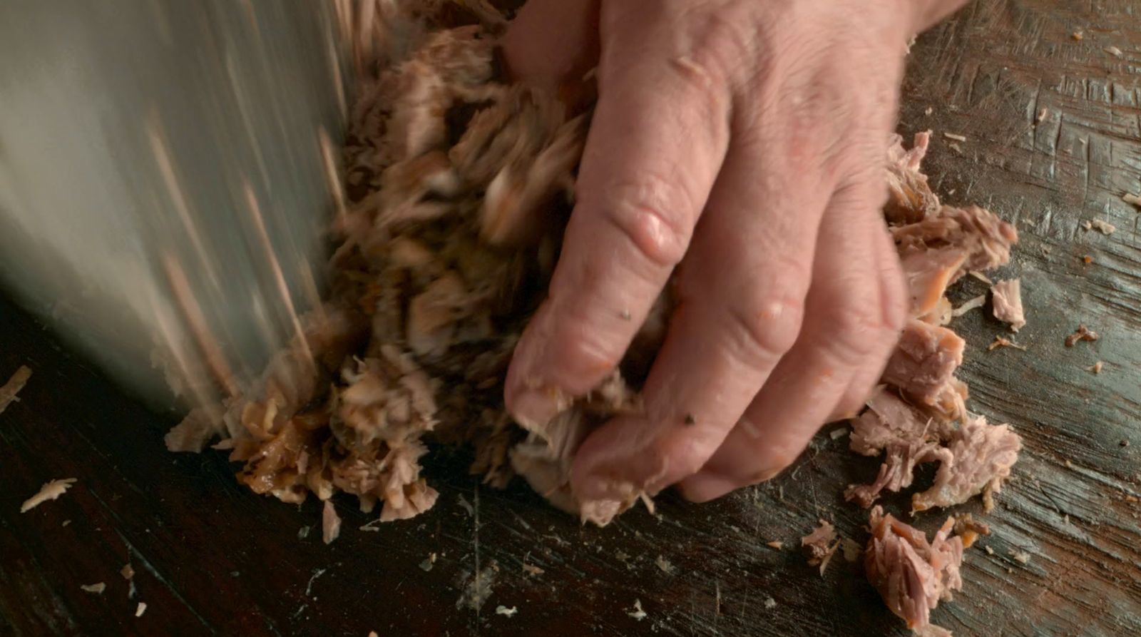 a person using a knife to cut wood