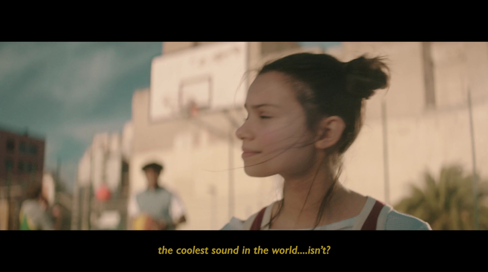 a girl is standing in front of a basketball court