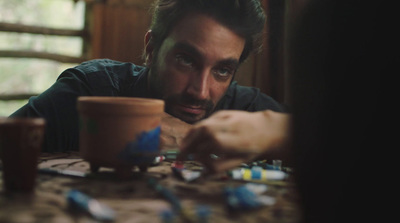 a man sitting at a table with a cup of coffee