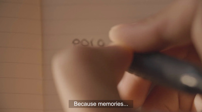 a close up of a person writing on a piece of paper