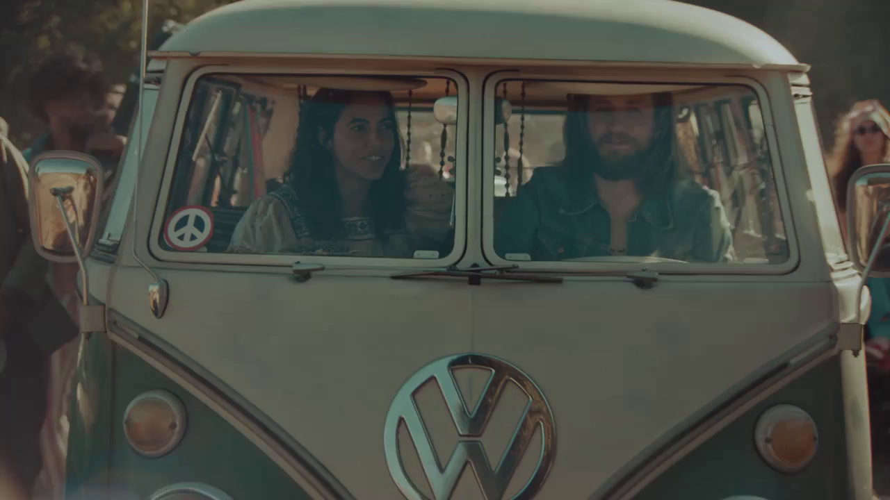 a vw bus with two people in it