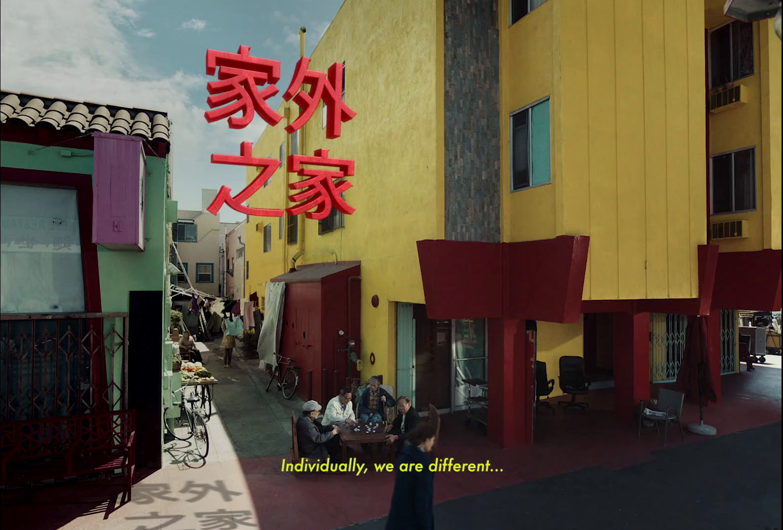 a group of people standing in front of a building with chinese writing on it