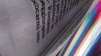 a close up of a book with a rainbow light coming out of it