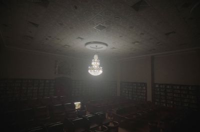 a chandelier hanging from the ceiling in a dark room