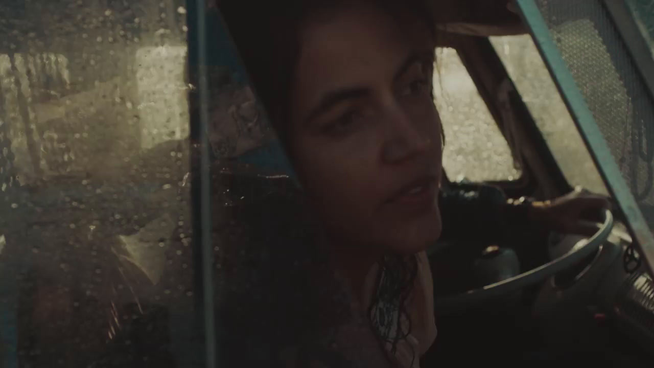 a man driving a car in the rain