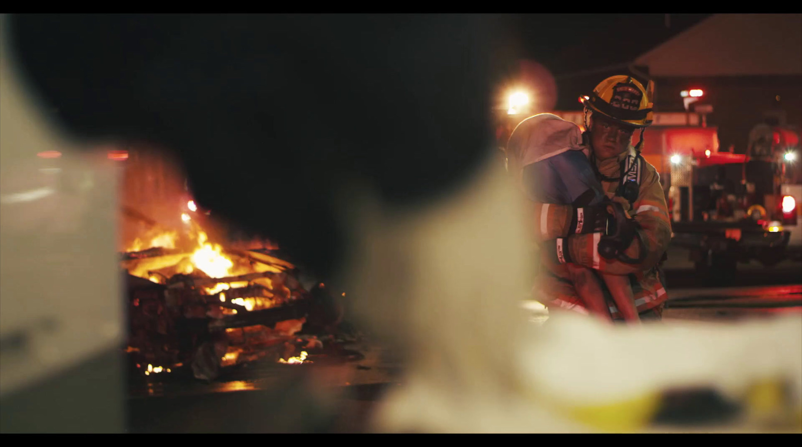 a firefighter sitting in front of a fire