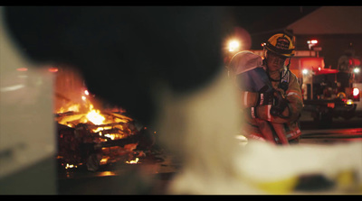 a firefighter sitting in front of a fire