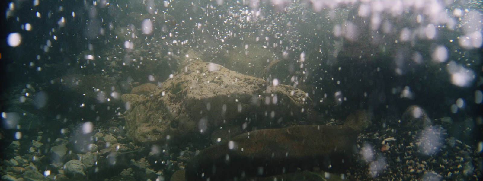 an underwater view of rocks and water