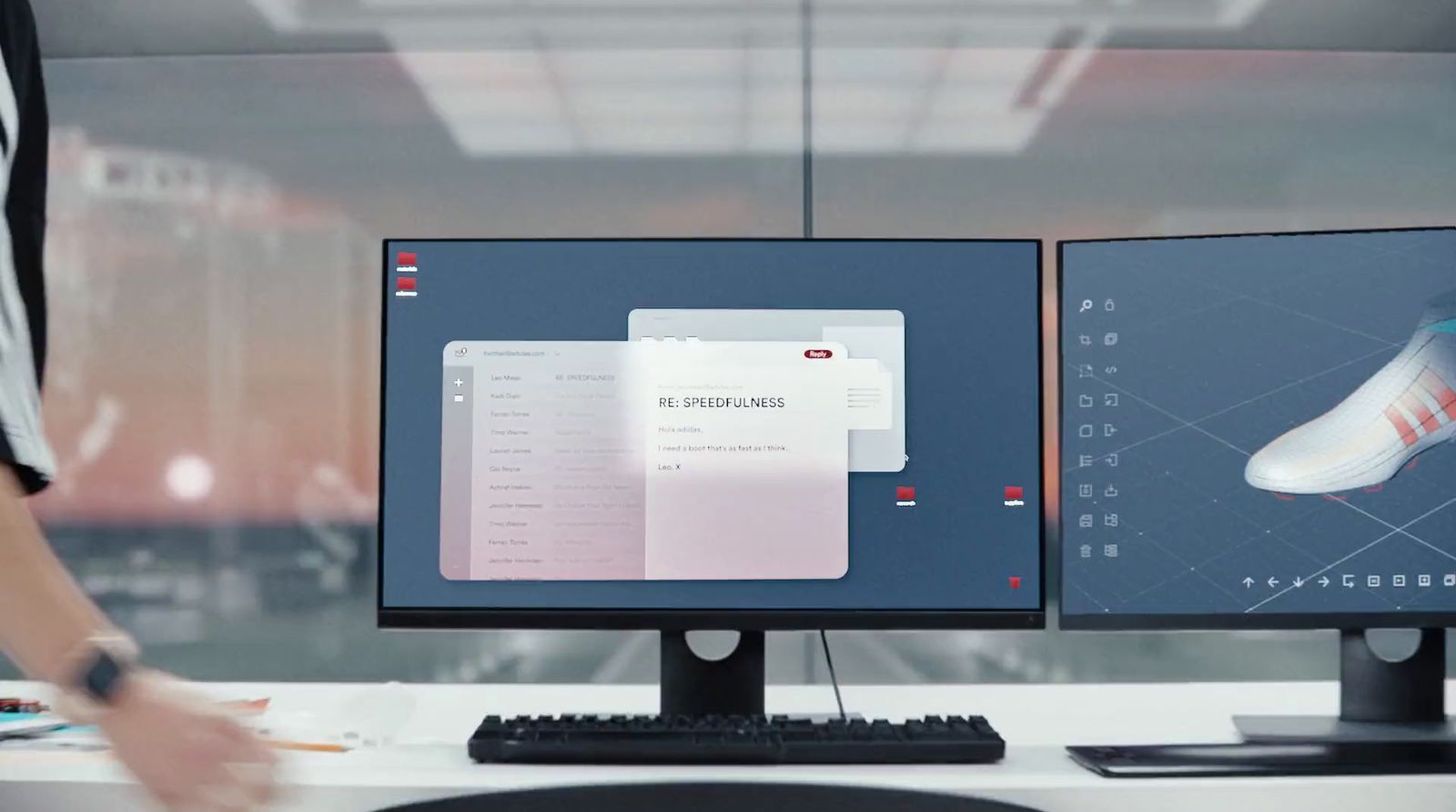 a person standing in front of two computer monitors