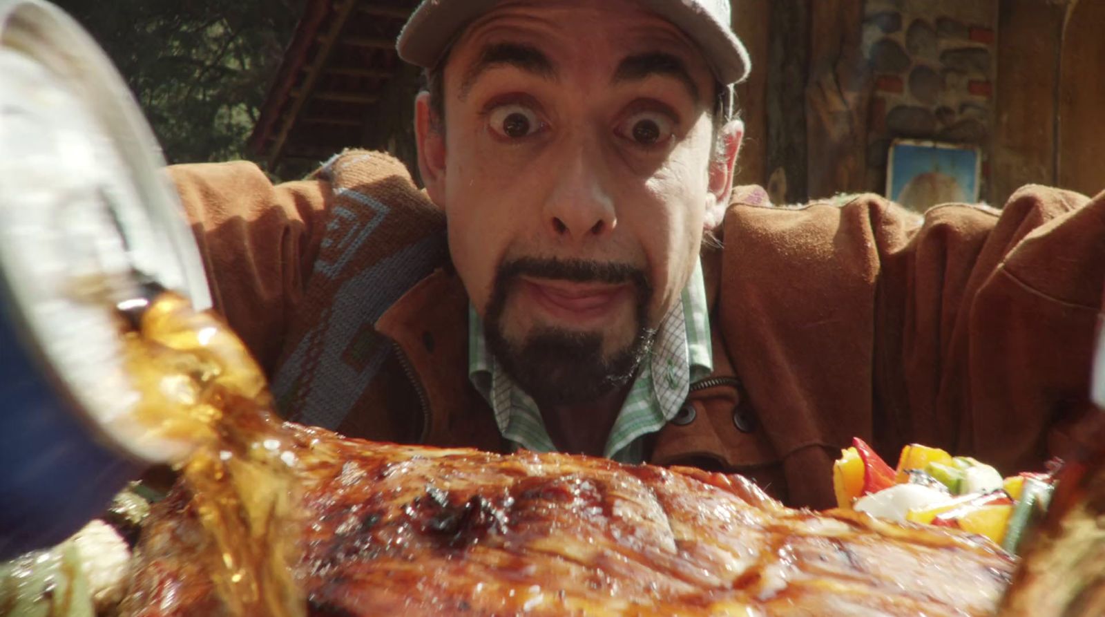 a man with a surprised look on his face next to a large piece of meat