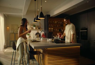 a man and a woman standing in a kitchen