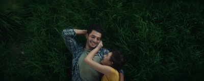 a man and a woman laying in the grass