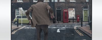 a man walking down the street in the rain