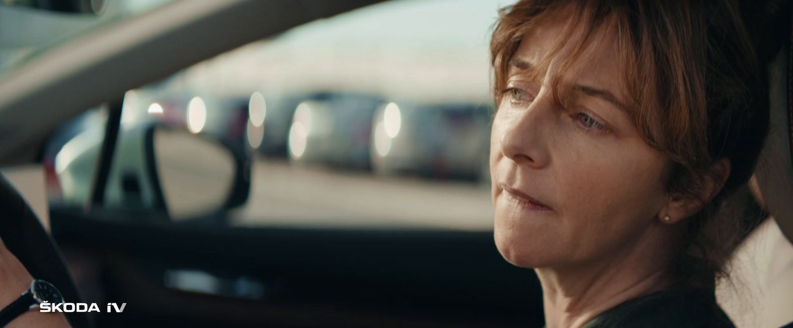 a woman sitting in a car looking out the window