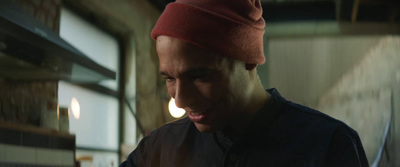 a man with a red hat is looking at his cell phone