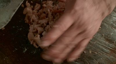 a close up of a person kneading food on a cutting board