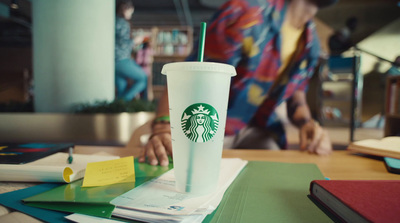 a starbucks cup sitting on top of a desk