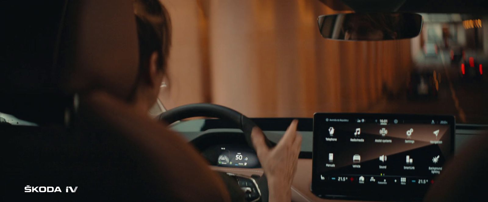 a woman driving a car at night with her hands on the steering wheel